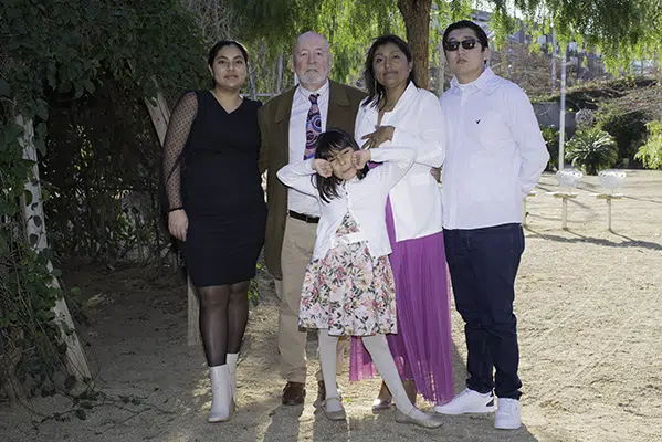 El amor entre los novios se refleja en la calidez de la familia del novio, quienes rodean con su presencia este momento tan especial, haciendo de esta foto un recuerdo invaluable de apoyo, alegría y compromiso.